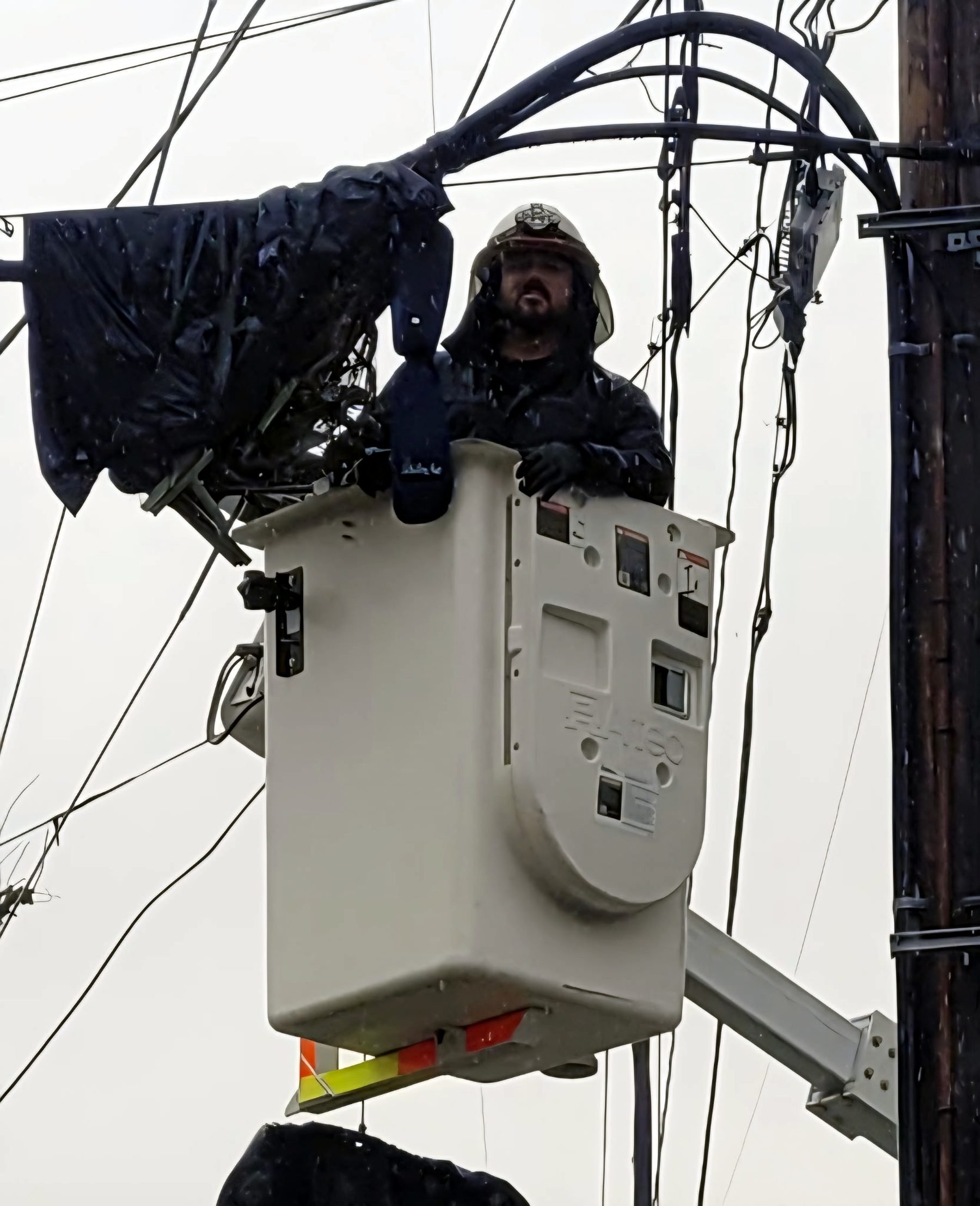 Working aerial lines from a bucket in the rain