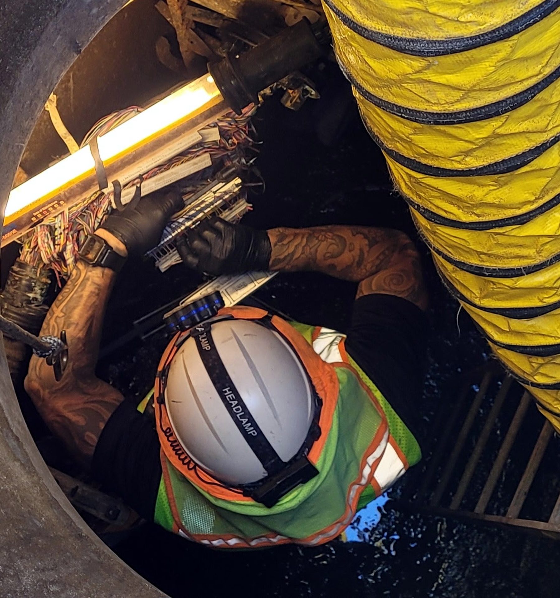 Fred Martinez splicing cable in a manhole